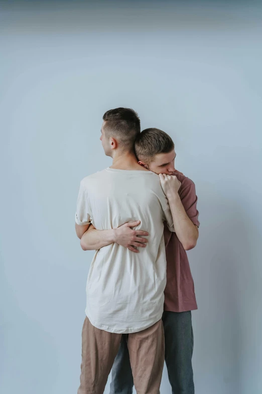 two men emce on a gray and blue background