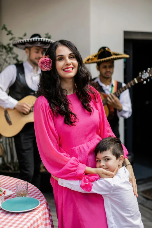 the woman is holding a small boy in her arms