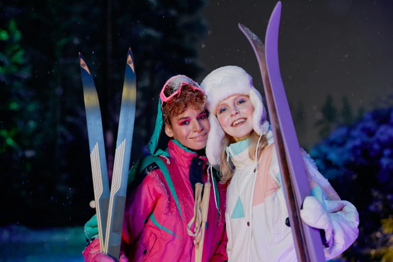 two people are posing with skis and a snowboard