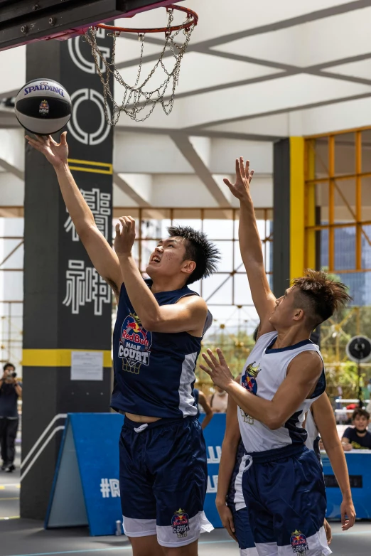 two basketball players are fighting for the ball