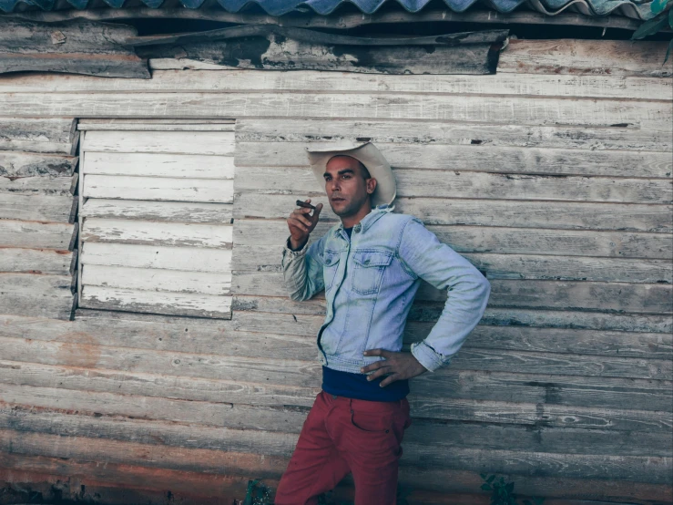 a man is smoking cigarette on the corner