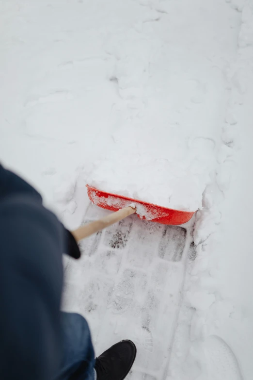 someone hing a snowboard on a snowy path