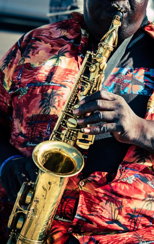 an african american male plays the saxophone on a sunny day