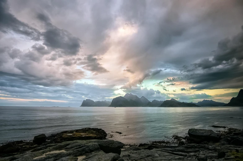 storm clouds loom above the rocky shore