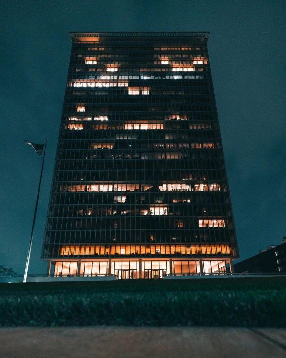 a tall tower with a clock in front of it at night