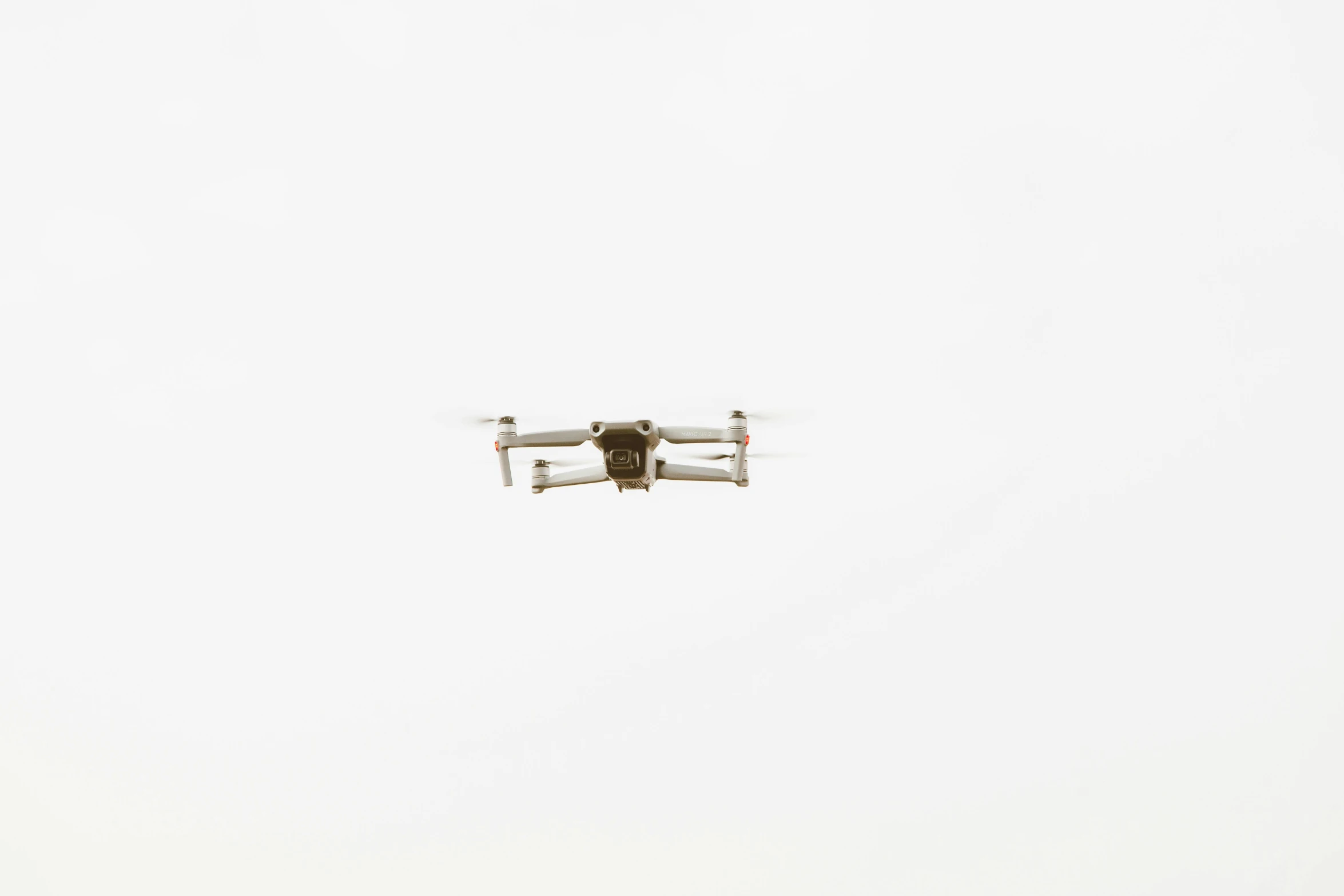 an airplane flying through the white sky