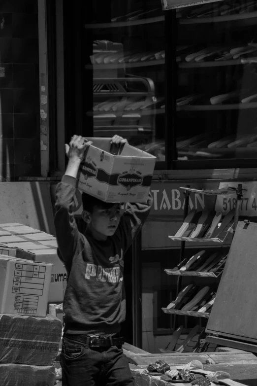 a  carrying boxes across his head