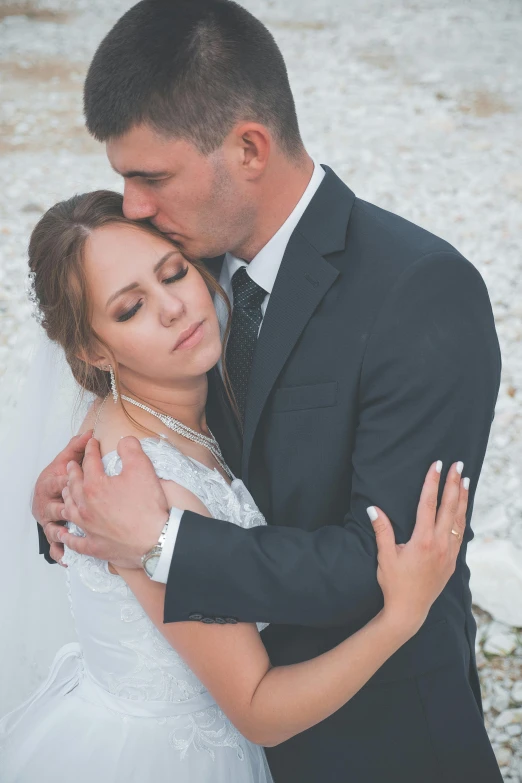 a bride and groom emce during their wedding pos