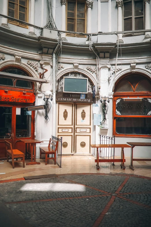 a room filled with furniture and tables on either side of a tv