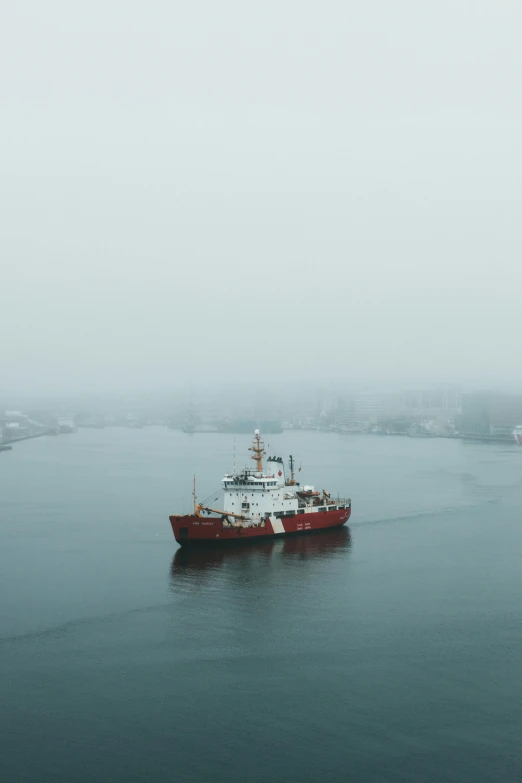 an orange and white boat in a harbor