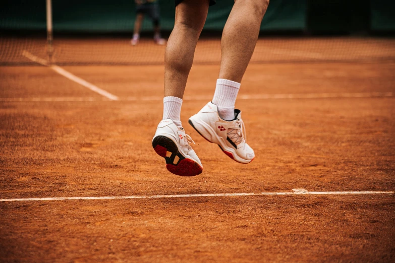 a person in the air with a tennis racket