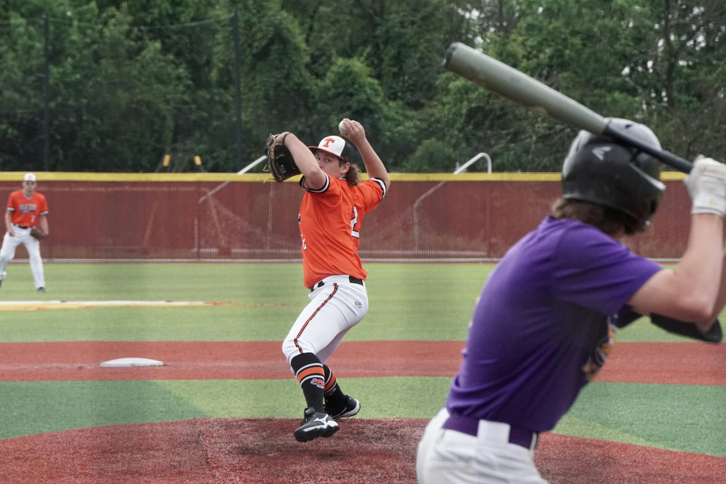 two baseball players trying to throw a ball