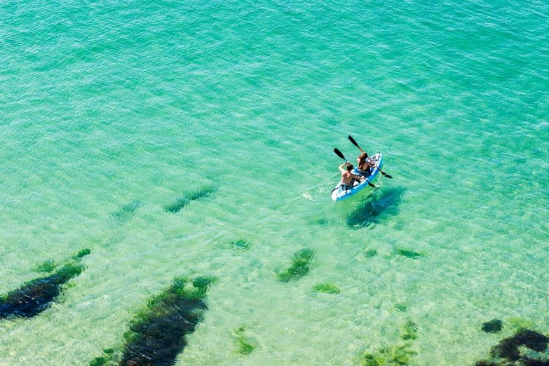 the paddle boat is in calm clear blue water