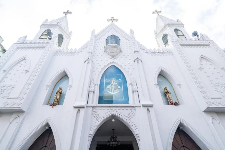 a white building with ornate windows and a door