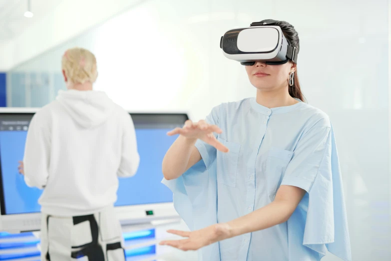 two people standing in front of the screen wearing virtuals