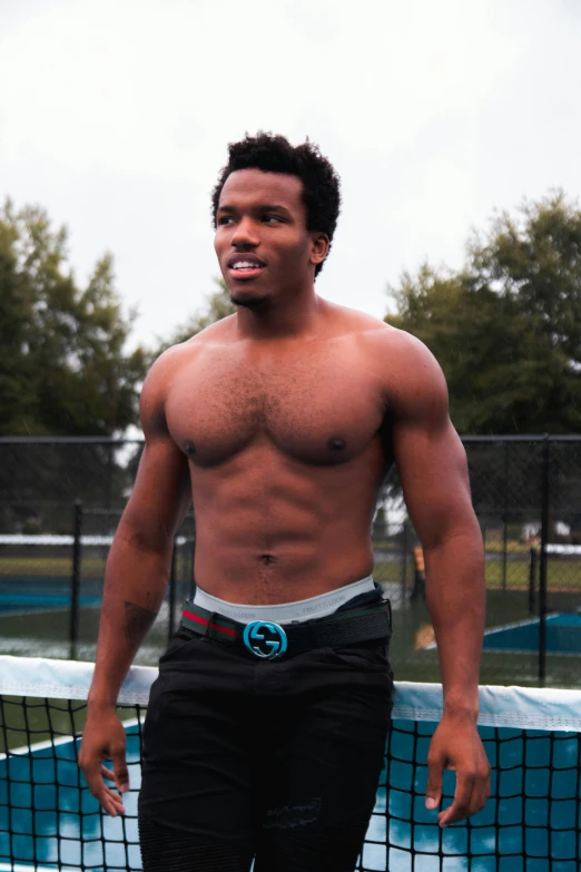 a young black man holding a tennis racquet