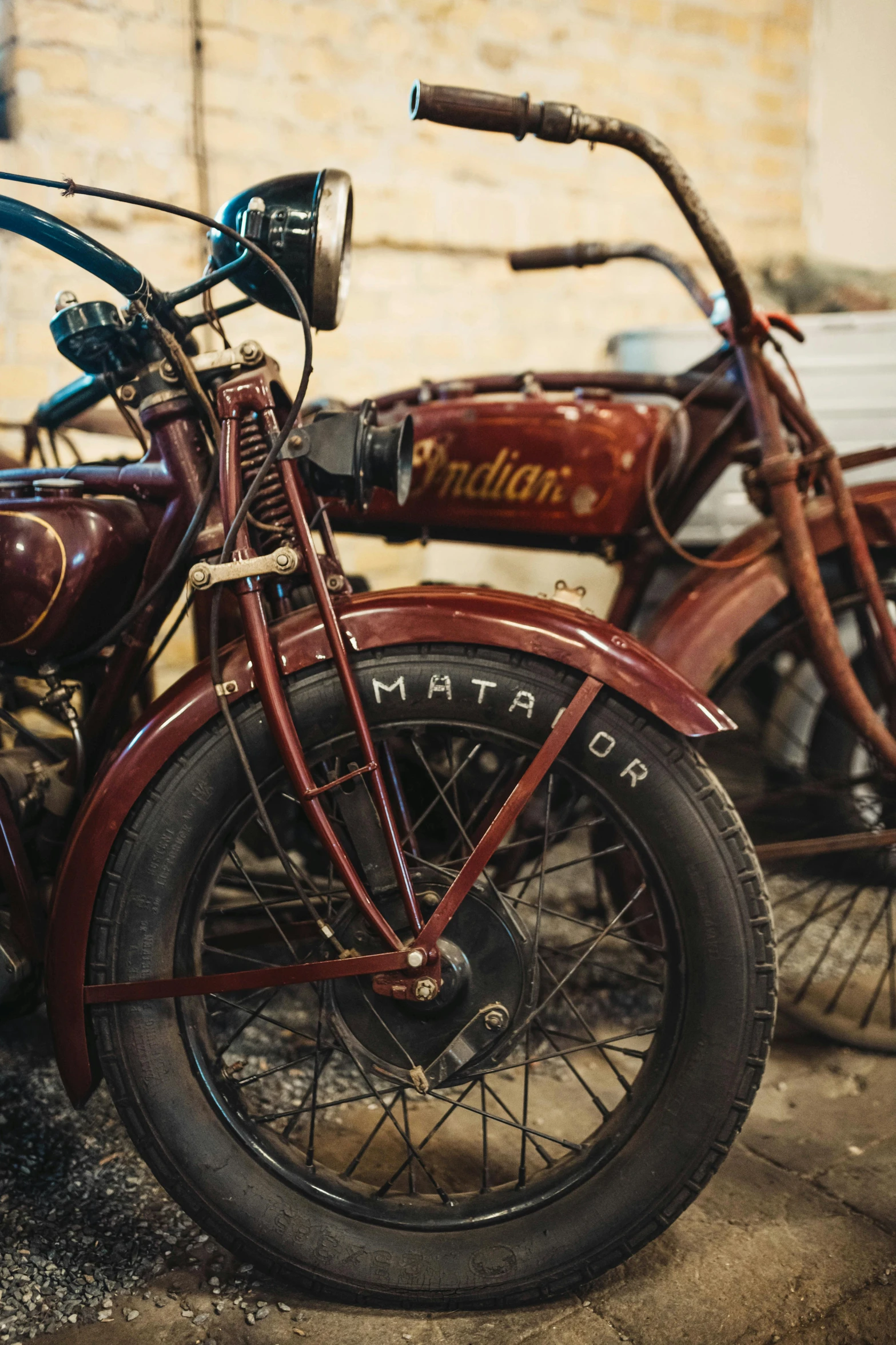 old motorcycles sitting side by side in a garage