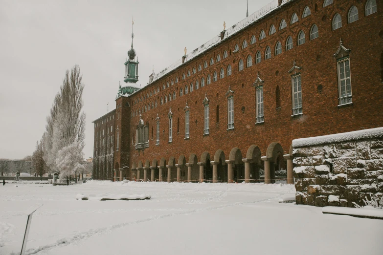 a snowy view of a building, with the surrounding area around it