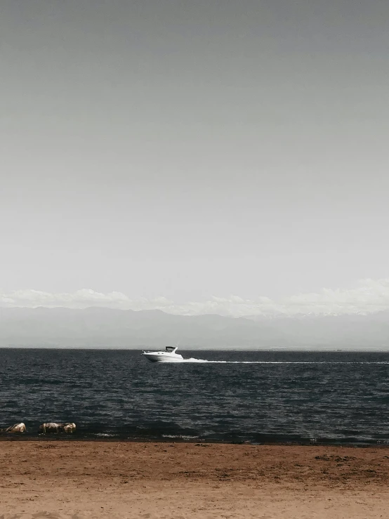 a lone boat in the middle of a body of water