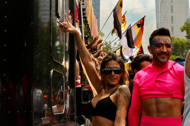 a man and woman in bathing suits stand on a side car of a train