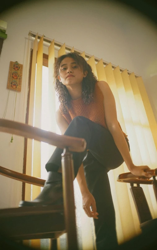 a woman sitting in a chair near a window