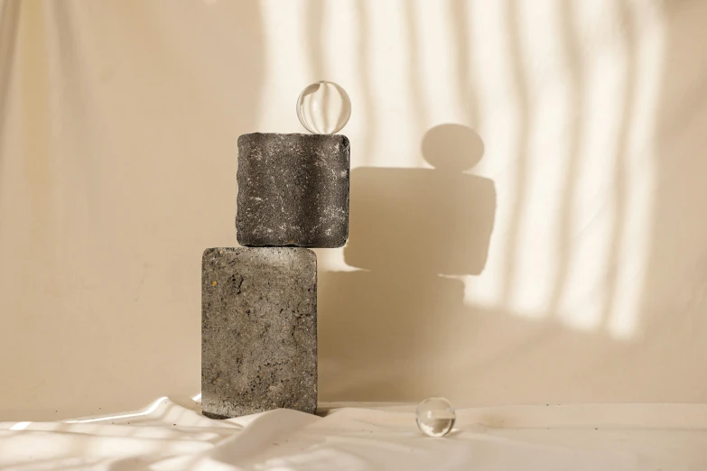 a small sculpture is standing against a wall