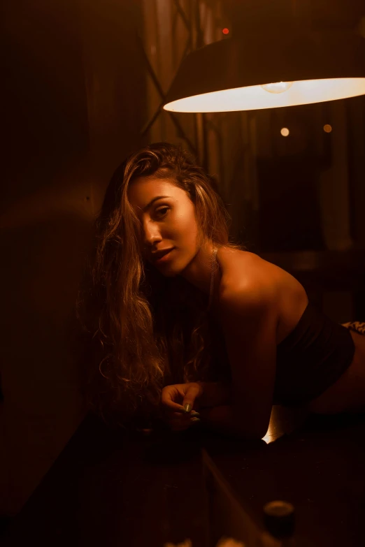 woman sitting on table in dimly lit room