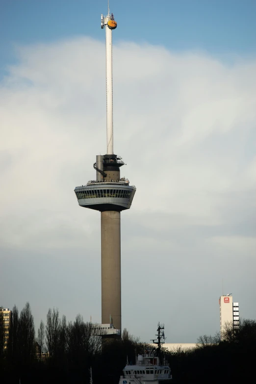 the tower has a lot of windows and a white object on it