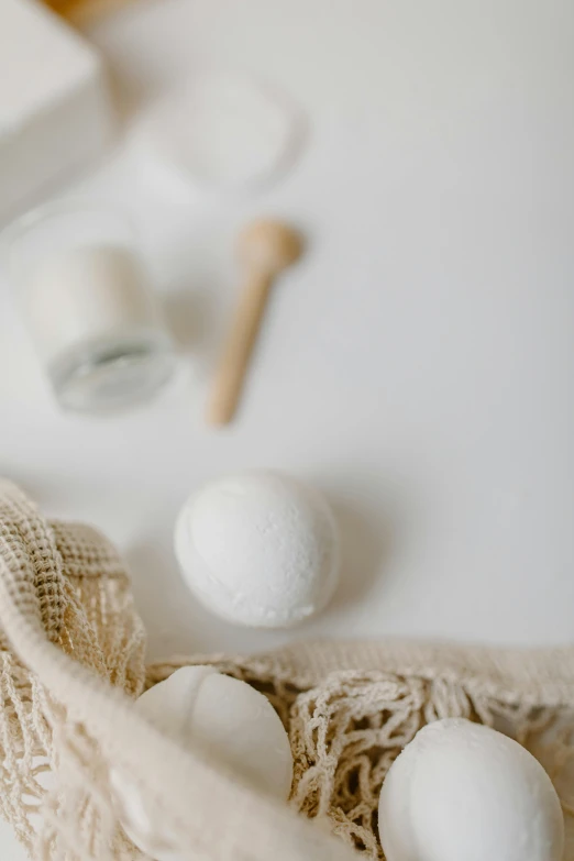 three white balls, cotton swab and a wooden rolling pin