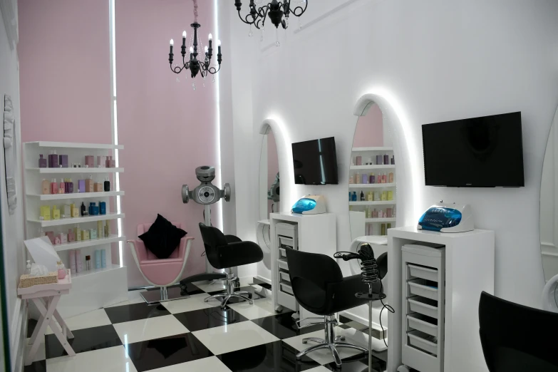 a white and black checkered floor with a nail salon