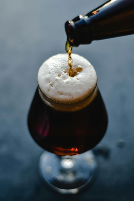 a person pours soing in a glass