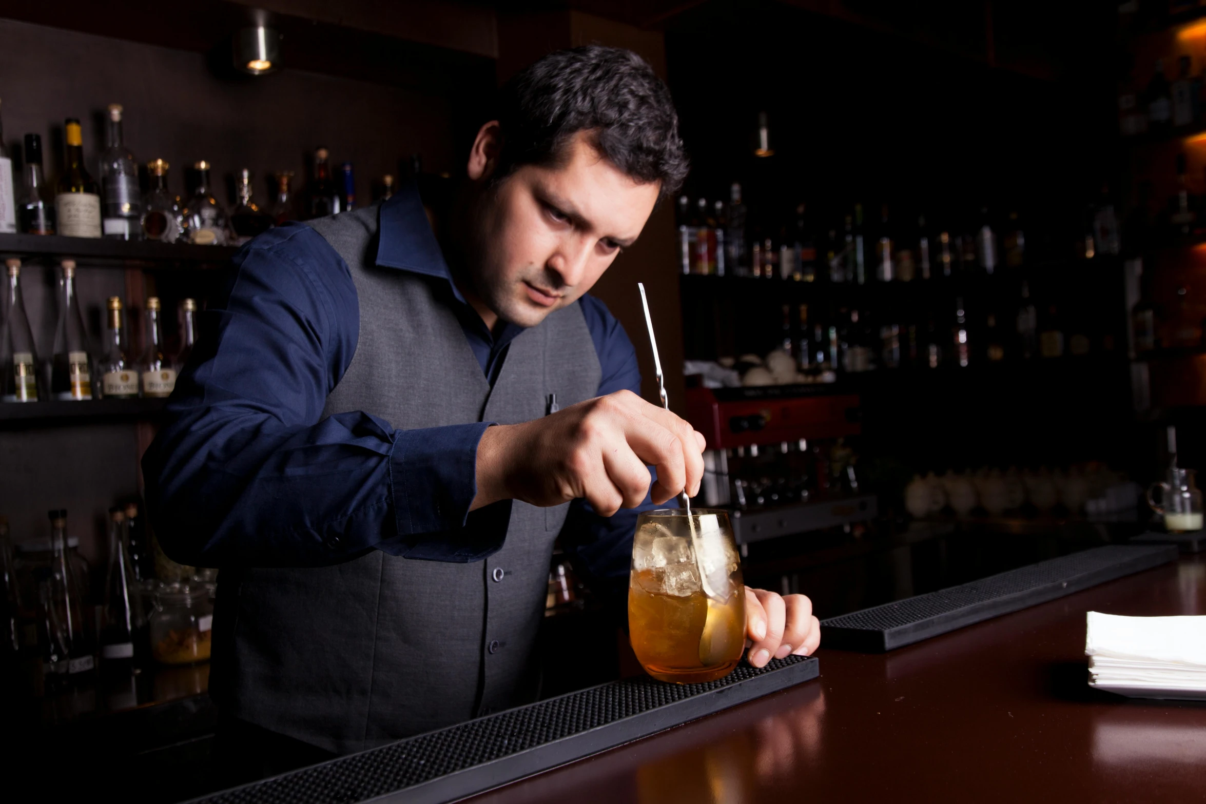 a man is holding a glass with a beverage