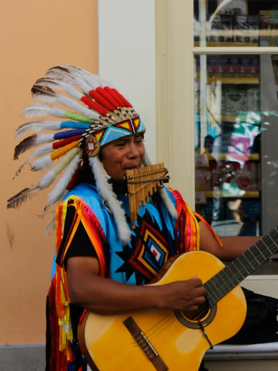 a native american native american playing a guitar