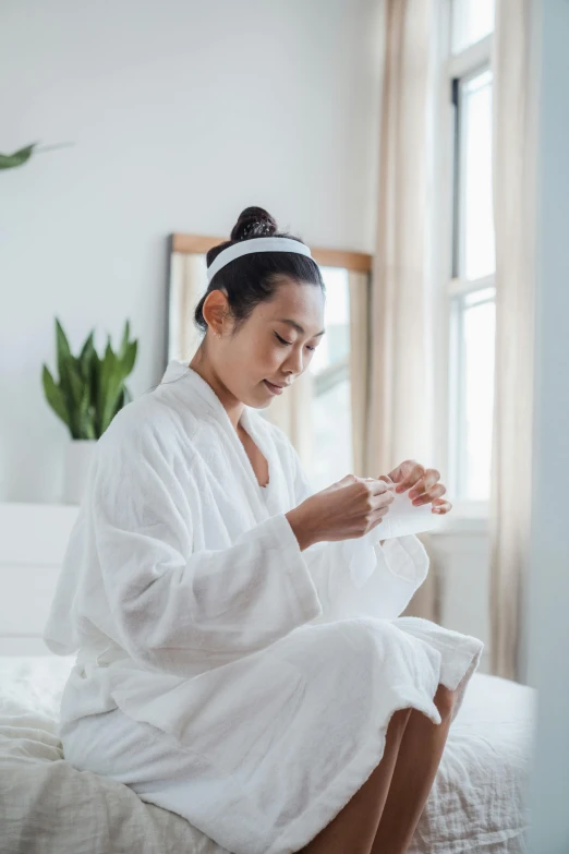 the woman is sitting in her bath robe