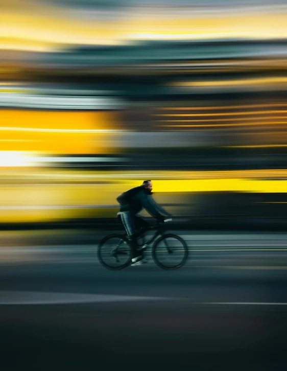 a blurry image of a bicyclist on a street