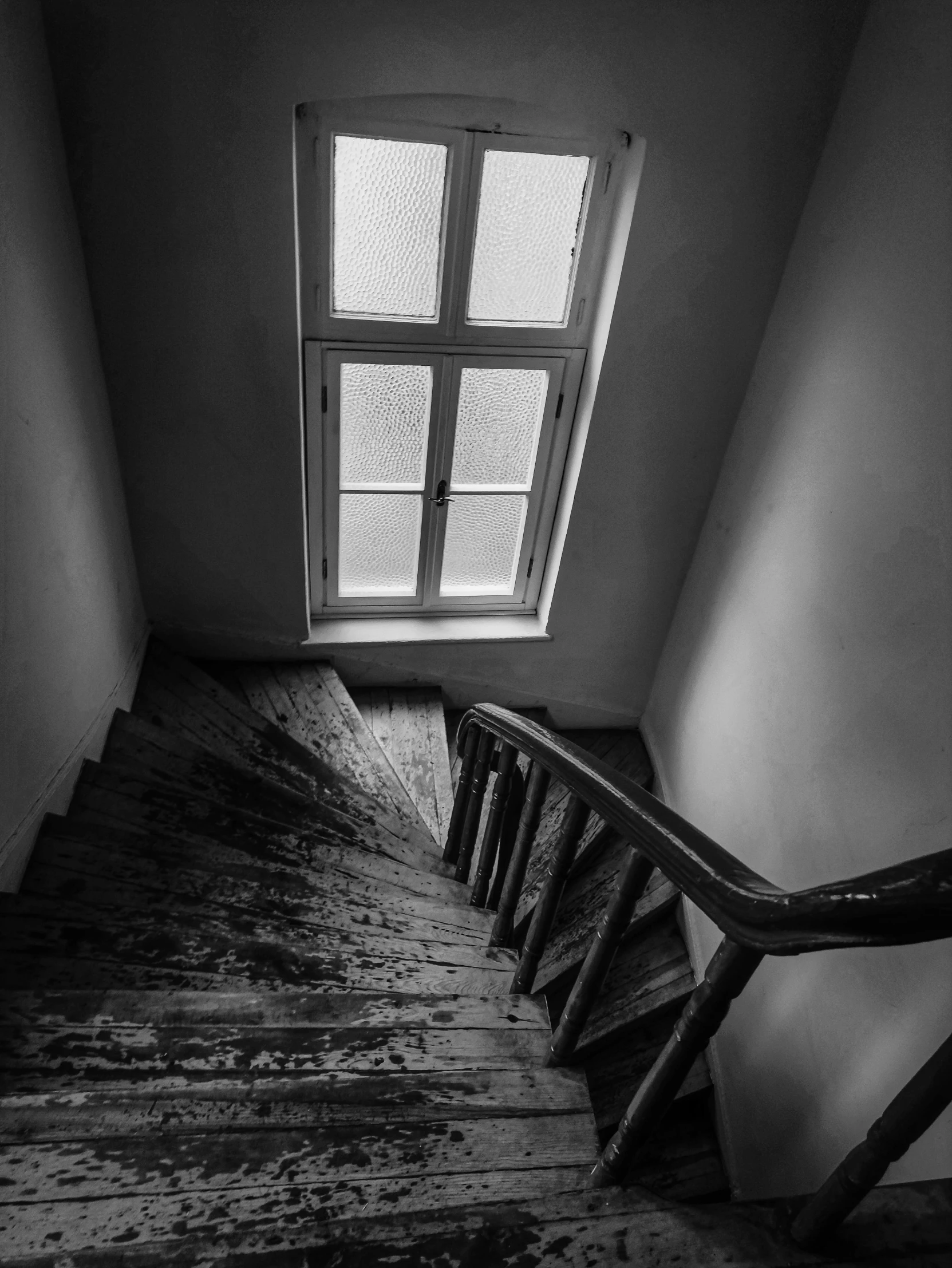 a stair is shown near a window in an empty room