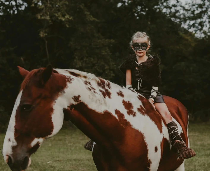 the girl is riding her horse in the field