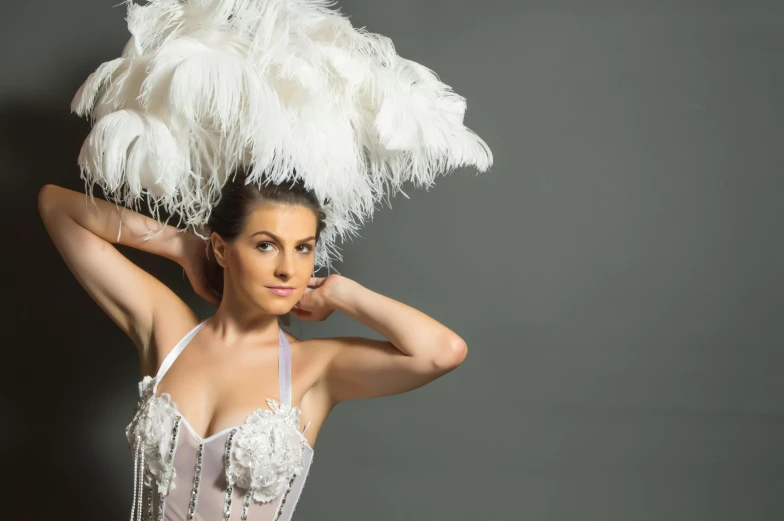 a woman is posing with a large headpiece