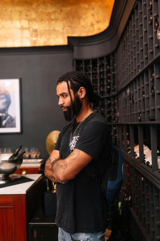 a man standing next to a wine rack in a shop