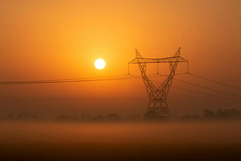 a power line in the distance in front of a hazy sky