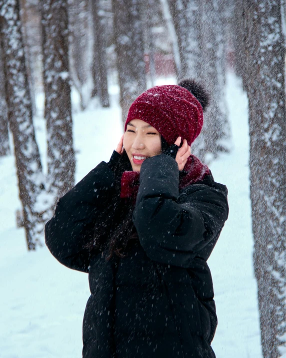 there is a woman talking on the phone in the snow