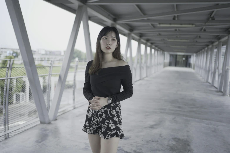 a woman posing in a black sweater and short shorts