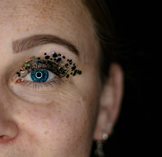 the face of a woman with a colorful face decoration