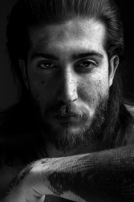 man with a beard looking away and wearing a tie