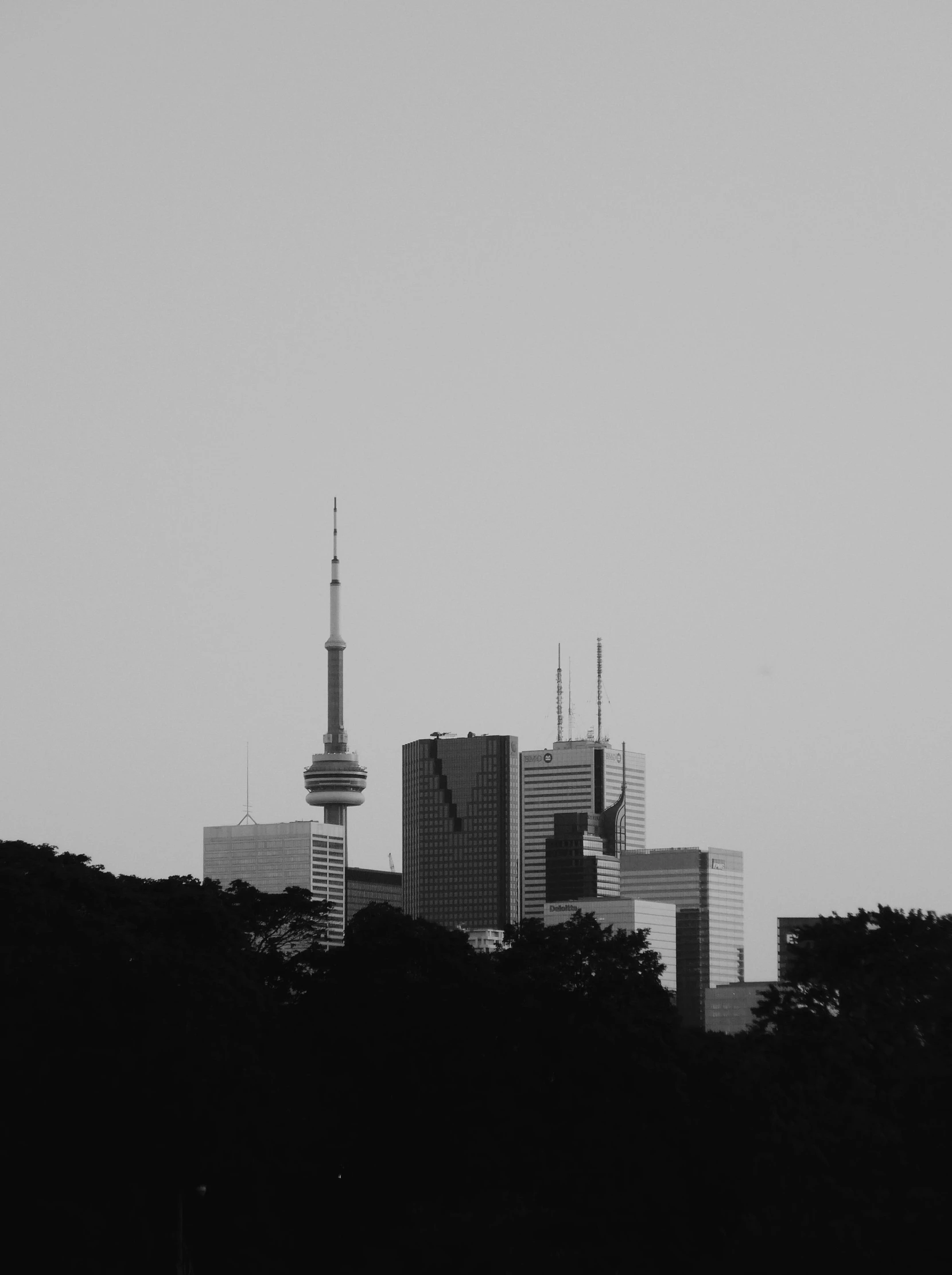 a city view with a plane flying over the top of a tower