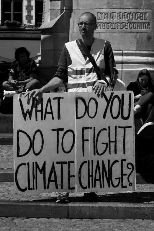 two people holding up signs with writing on them