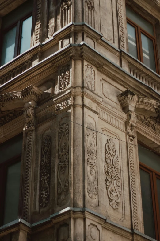 the corner of a large building with decorative architectural designs