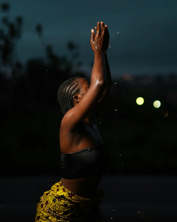 a woman in bathing suit waving at night