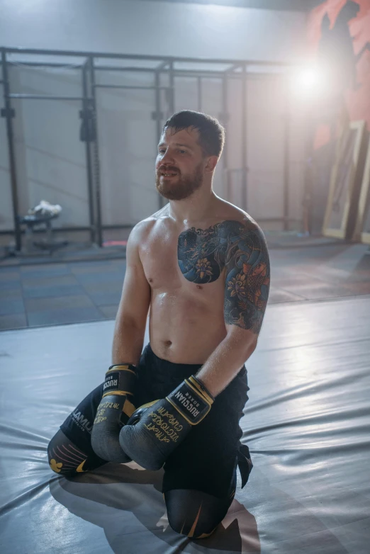 a man is sitting in the middle of a gym