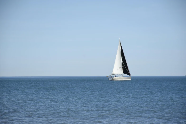 a boat floating on top of a blue body of water